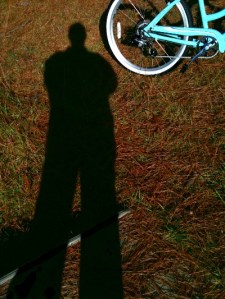 shadow of photographer and bicycle wheel